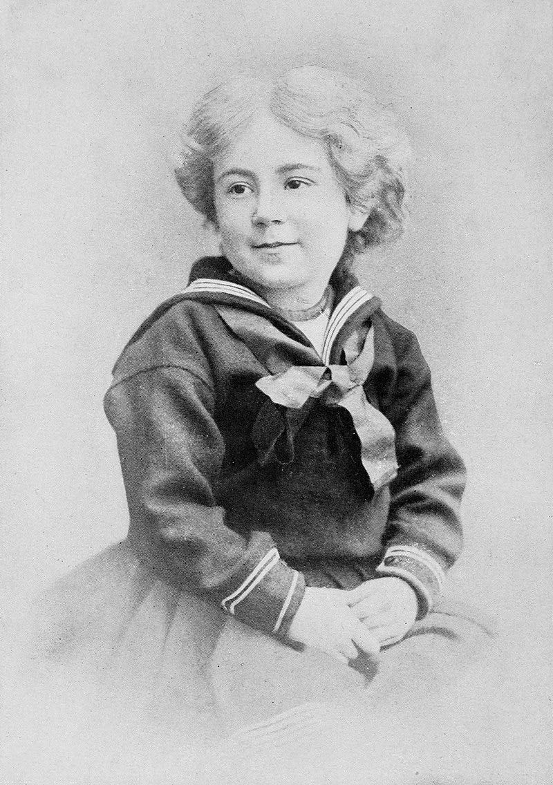 3/4 angle portrait of little girl, about age 5, in sailor dress