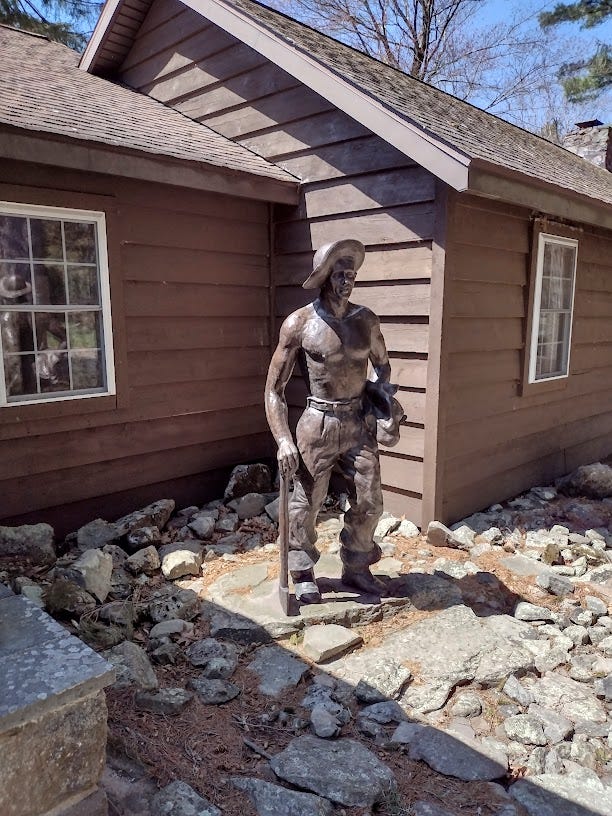 Statue of young man in front of building