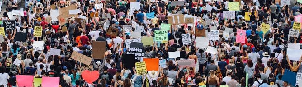 a large group of people holding up signs