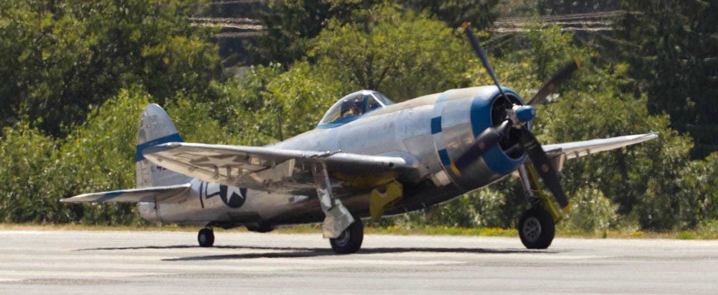 A single-propeller plane taxis down the runway.