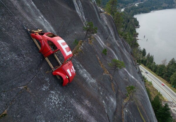 The shell of a Volkswagen Beetle hangs suspended on a cliff above the Sea-to-Sky Highway, in Squamish, British Columbia, Monday, April 6, 2026, after it appeared on the rock face last week with a large "E" on its roof, indicating that University of British Columbia engineering students carried out a long-standing tradition of placing the shell in difficult to reach locations. (Darryl Dyck/The Canadian Press via AP) The shell of a Volkswagen Beetle hangs suspended on a cliff above the Sea-to-Sky Highway, in Squamish, British Columbia, Monday, April 6, 2026, after it appeared on the rock face last week with a large "E" on its roof, indicating that University of British Columbia engineering students carried out a long-standing tradition of placing the shell in difficult to reach locations. (Darryl Dyck/The Canadian Press via AP)