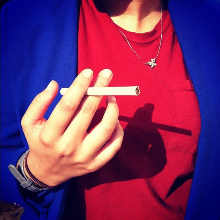 a woman holds a cigarette