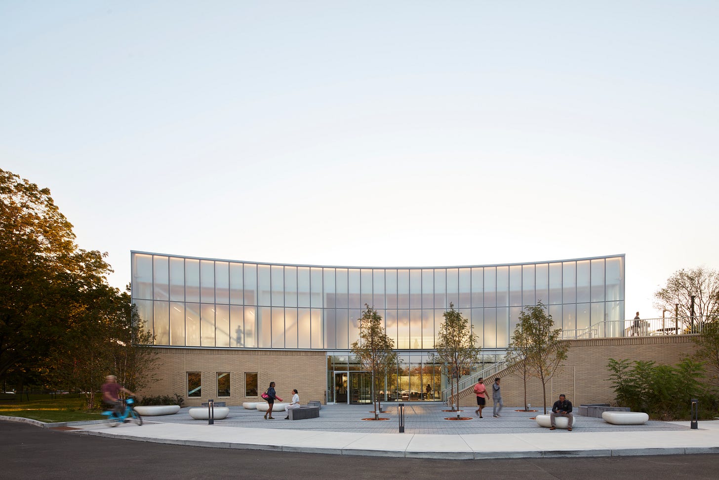Sunset wide shot of Gensler’s The Hub at Prairie Shores, modern architecture with people outside