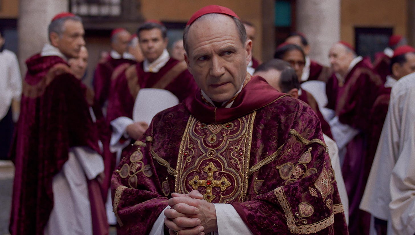 Ralph Fiennes in Catholic cardinal attire looking concerned
