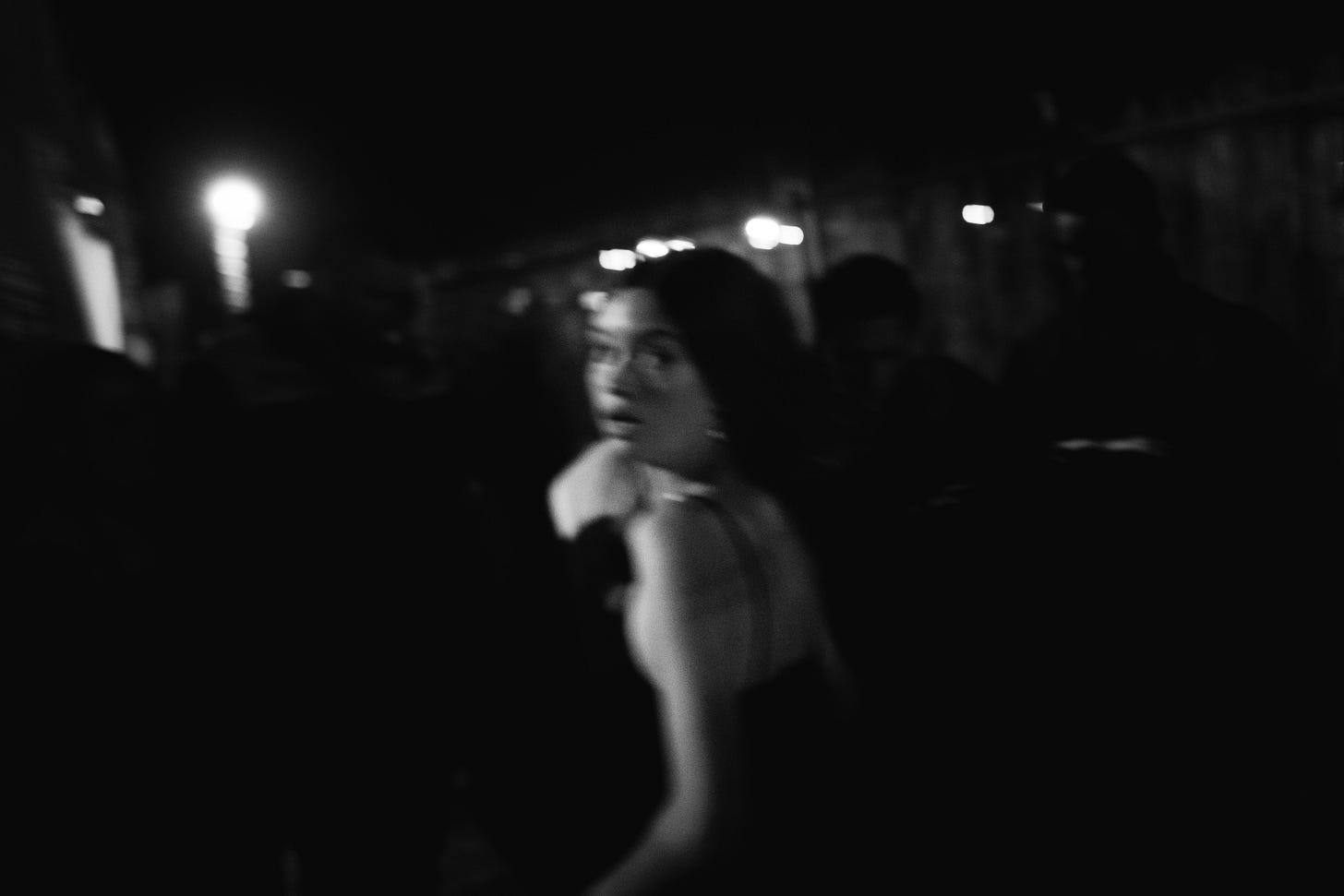 black & white image of girl in party dress looking over her shoulder