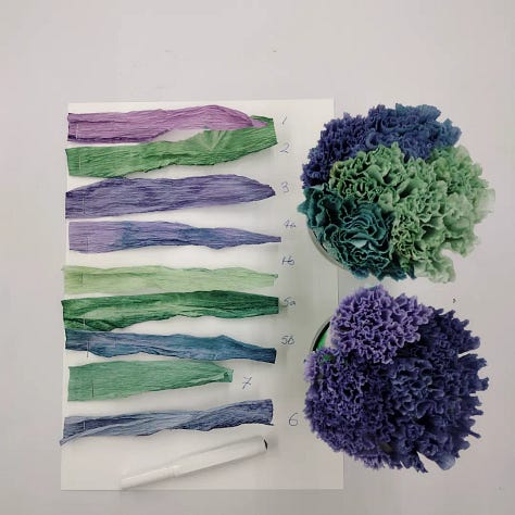 Pictures of red cabbage and papers dyed using red cabbage in December 2022. Bright jewel tones of green, turquoise, blues, lilacs and purples.