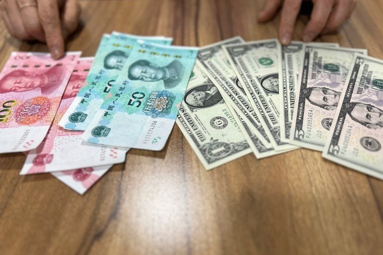 Chinese yuan and US dollar notes, side by side on a table, in Seoul, South Korea, on May 3, 2023 Chinese yuan and US dollar notes, side by side on a table, in Seoul, South Korea, on May 3, 2023