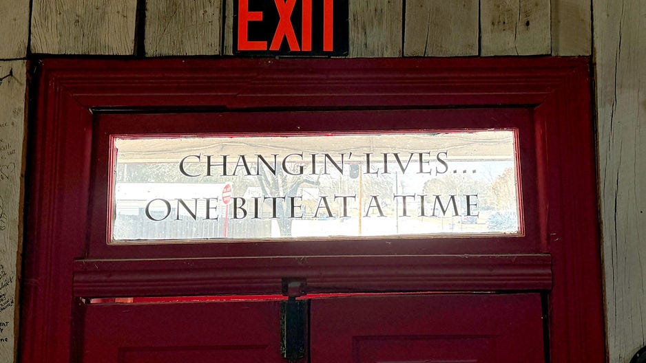 Changin' Lives... One Bite at a Time hung over the front door of the restaurant for 17 years. 