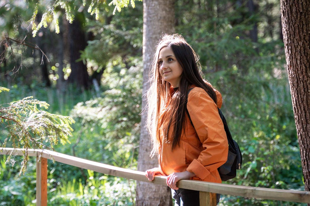 Woman out hiking alone, looking happy