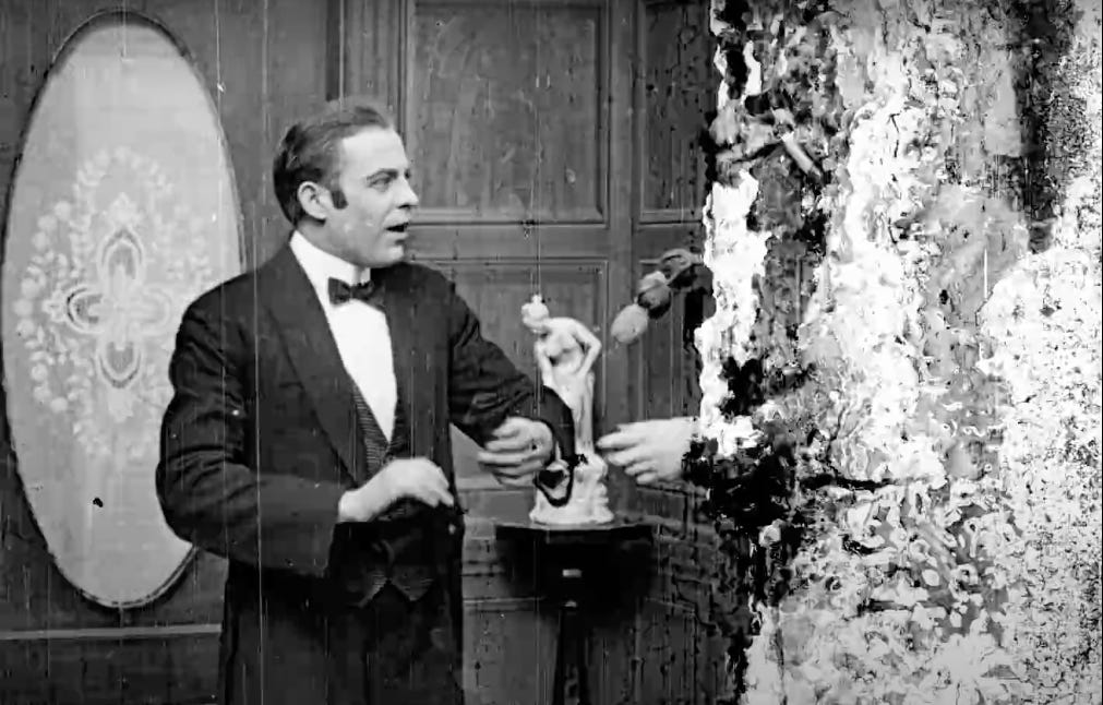 a hand reaches out from a flurry of crumbling film stock in Bill Morrison's 2016 film Dawson City: Frozen Time