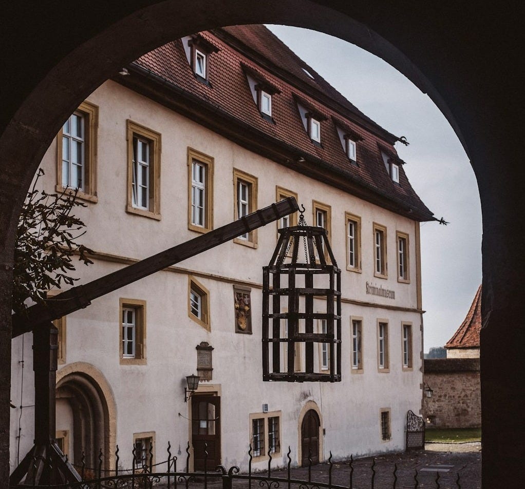 a large white building with a black gate