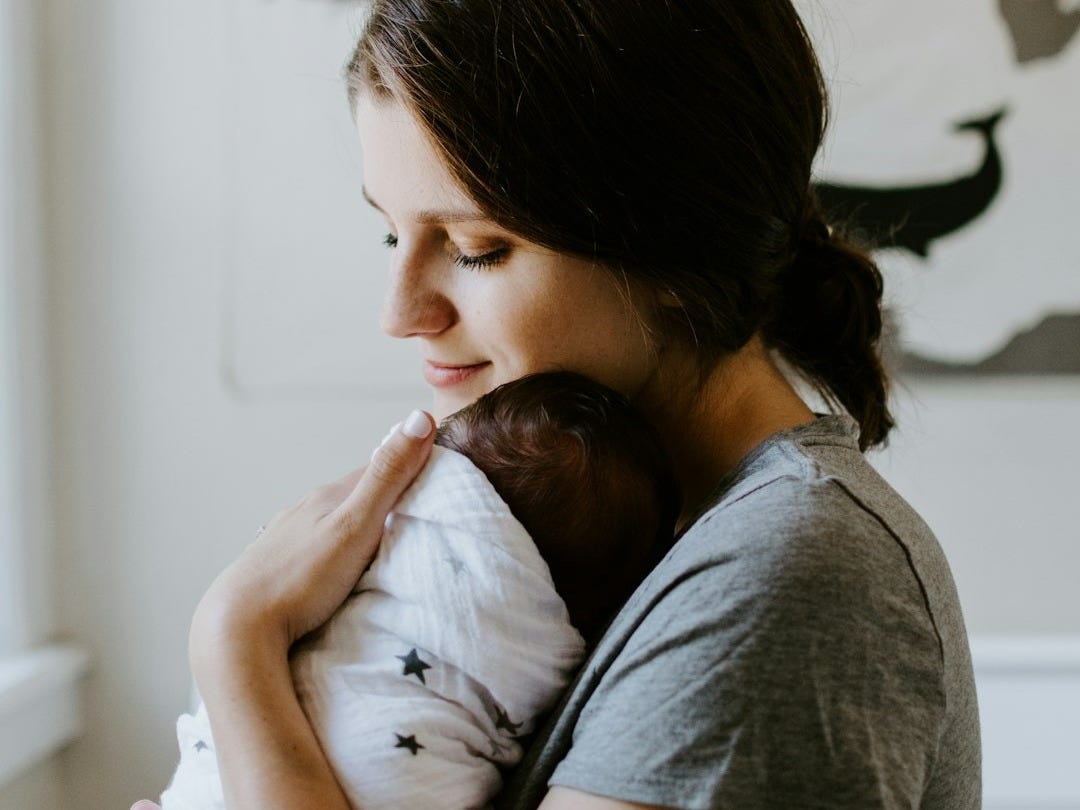 mother carrying baby mother carrying baby