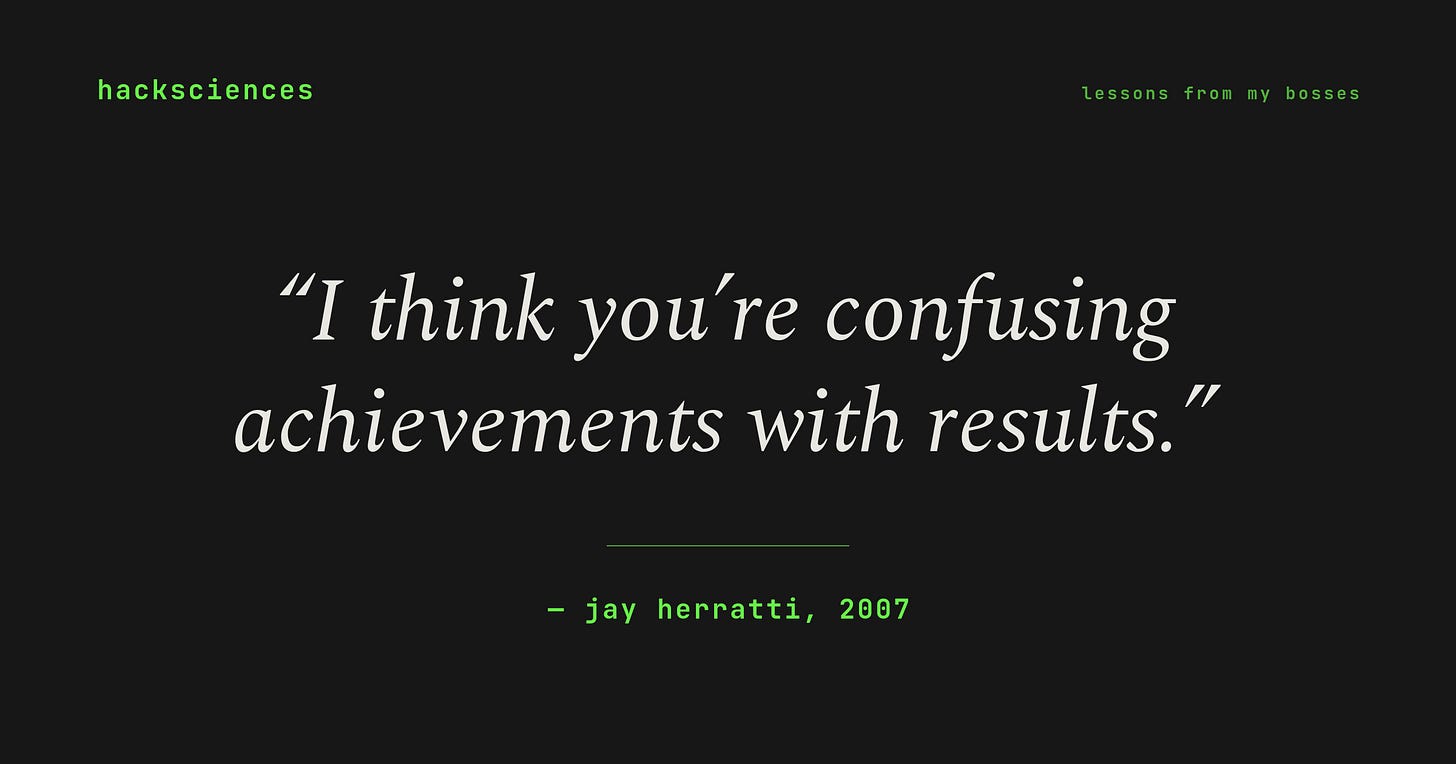 Quote card on a dark background reading 'I think you're confusing achievements with results.' attributed to Jay Herratti, 2007. Marked with the hacksciences wordmark and the section tag 'lessons from my bosses.'