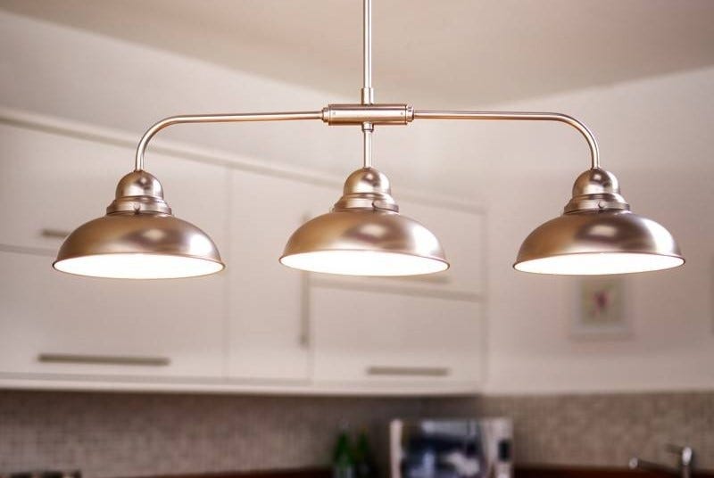 "Modern kitchen pendant lighting illuminating countertops with elegant design. Stylish hanging lights add warmth and sophistication to contemporary kitchen spaces."