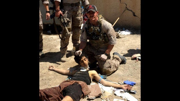 A soldier helping a child with an object

AI-generated content may be incorrect.
