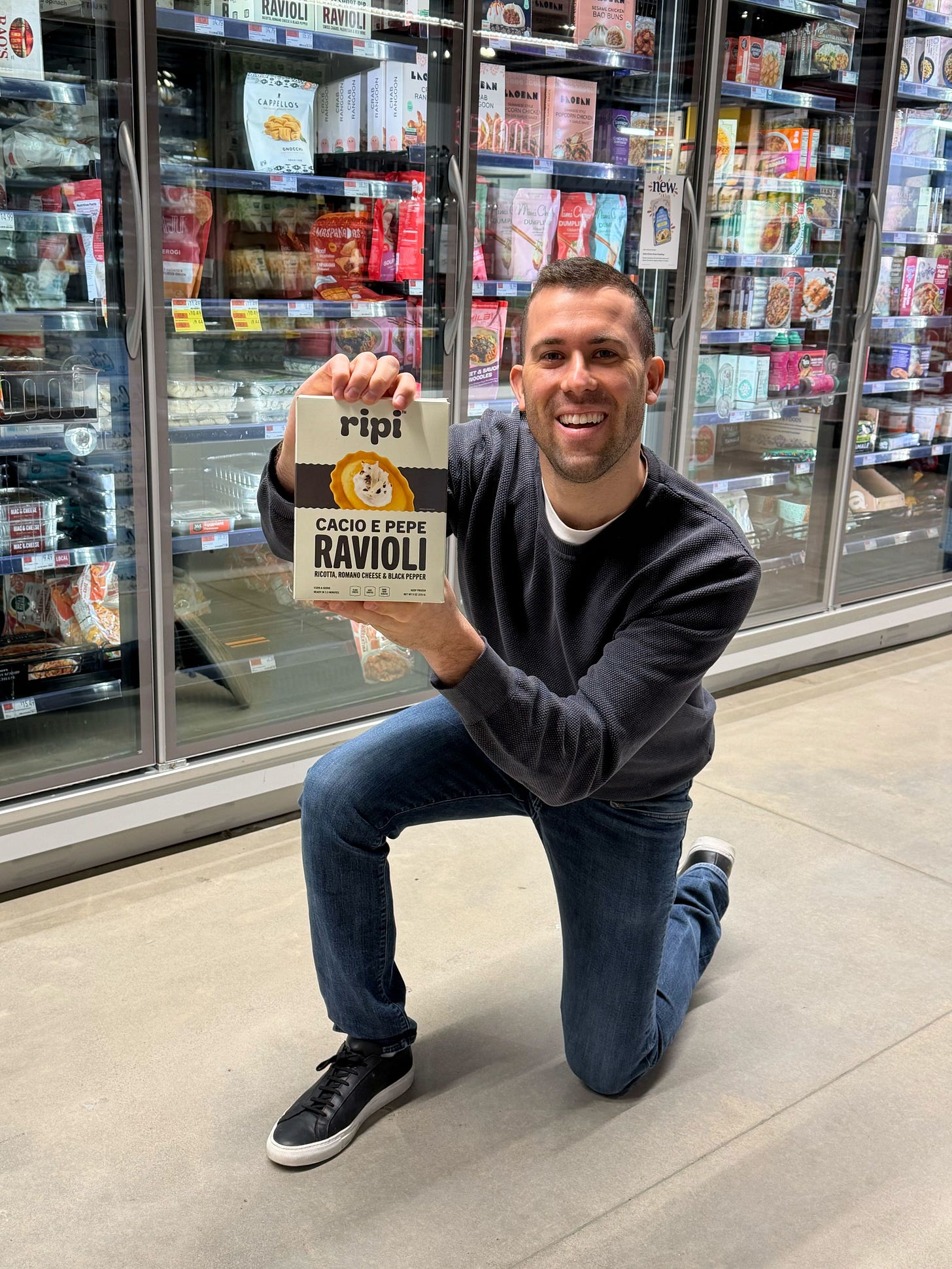 Ian Tecklin, founder of Ripi holding a box of Ripi Ravioli in the grocery store