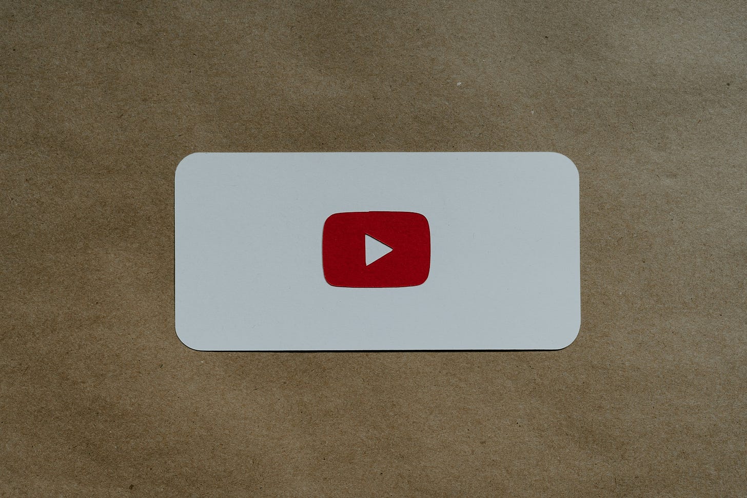 A white card with a red youtube logo on it.
