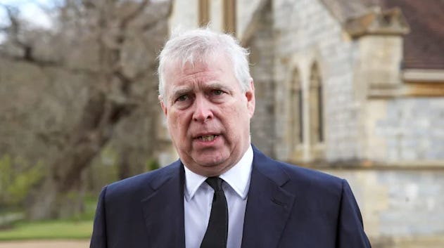 Prince Andrew frowning in a suit