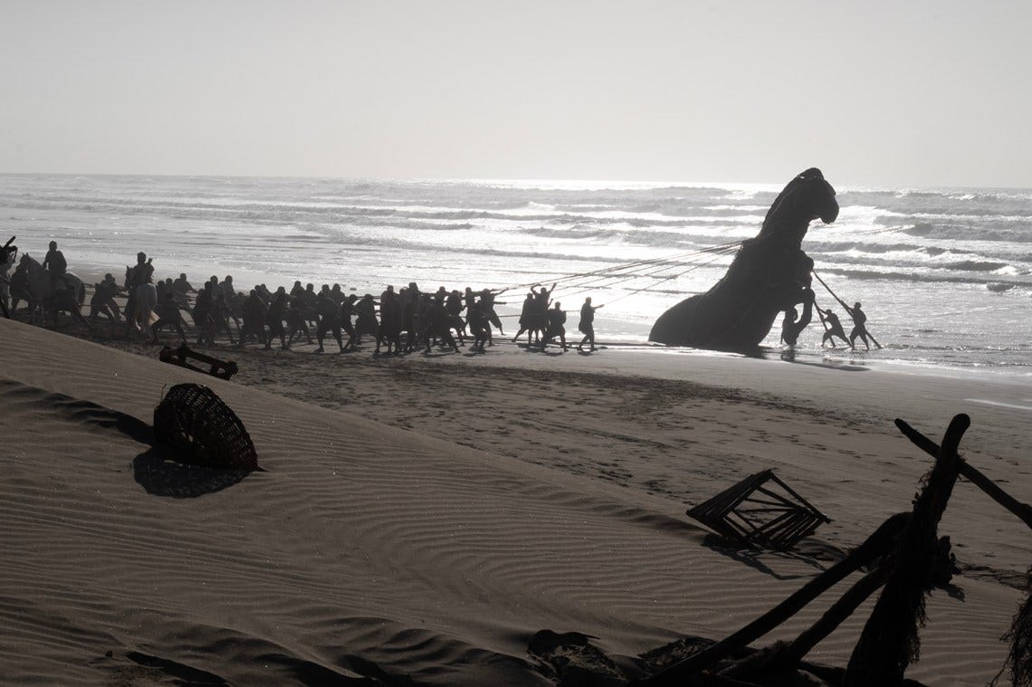 The Trojans dragging the wooden horse back to Troy; from Christopher Nolan’s The Odyssey The Trojans dragging the wooden horse back to Troy; from Christopher Nolan’s The Odyssey