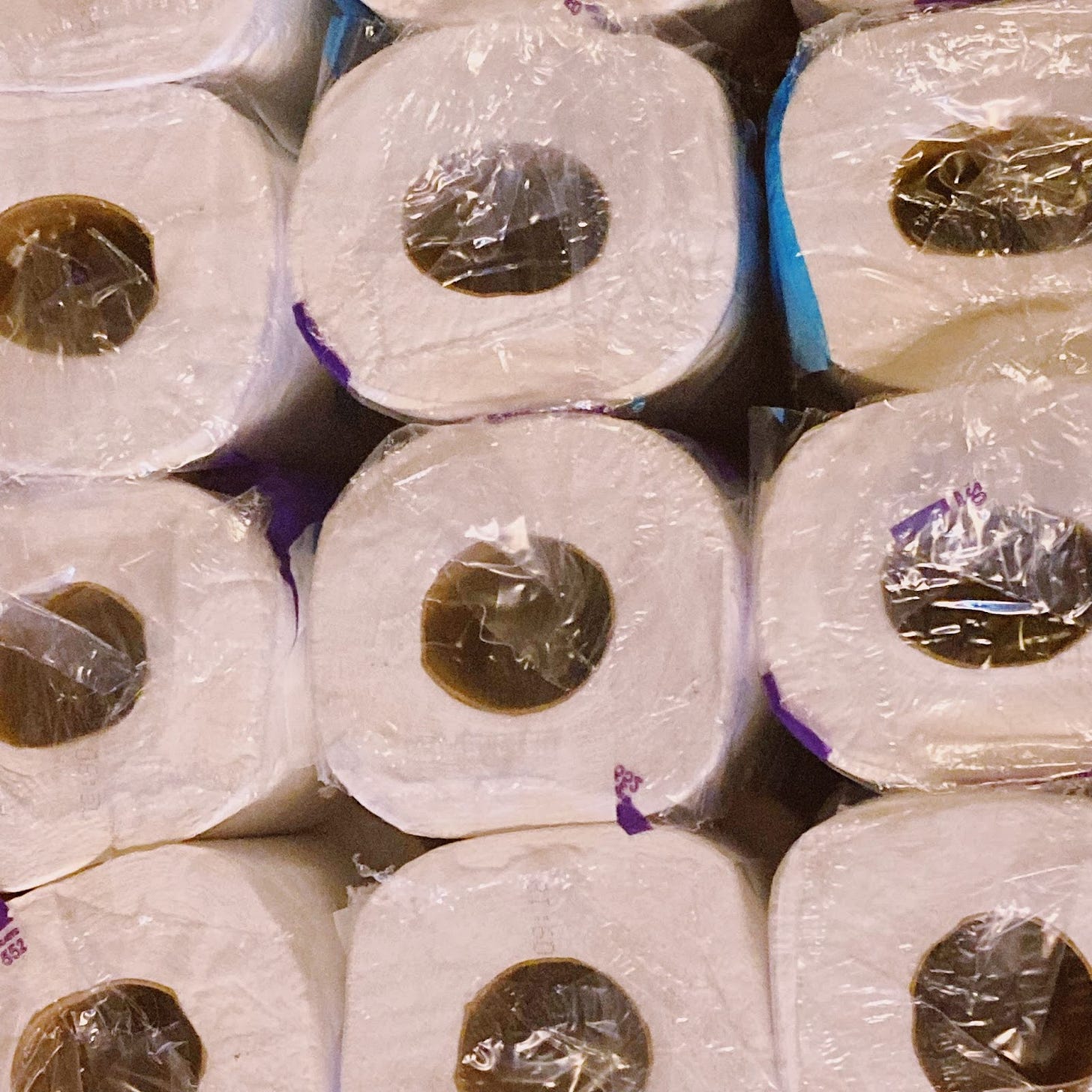 a close up of a pack of toilet paper covered in plastic