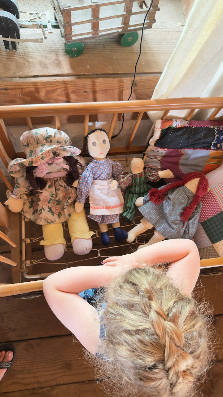 The inside of a wealthy family’s sod house. | A small girl looking at a crib full of handmade dolls. | The exterior of a falling-apart sod house. | The inside of a poor family’s house with a rusting washboard and a tin pitcher.