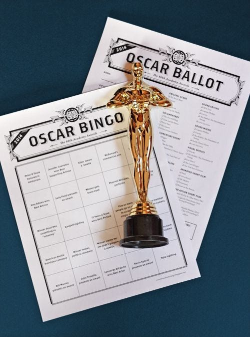This may contain: an oscar award is placed on top of a sheet of paper next to a golden statue This may contain: an oscar award is placed on top of a sheet of paper next to a golden statue