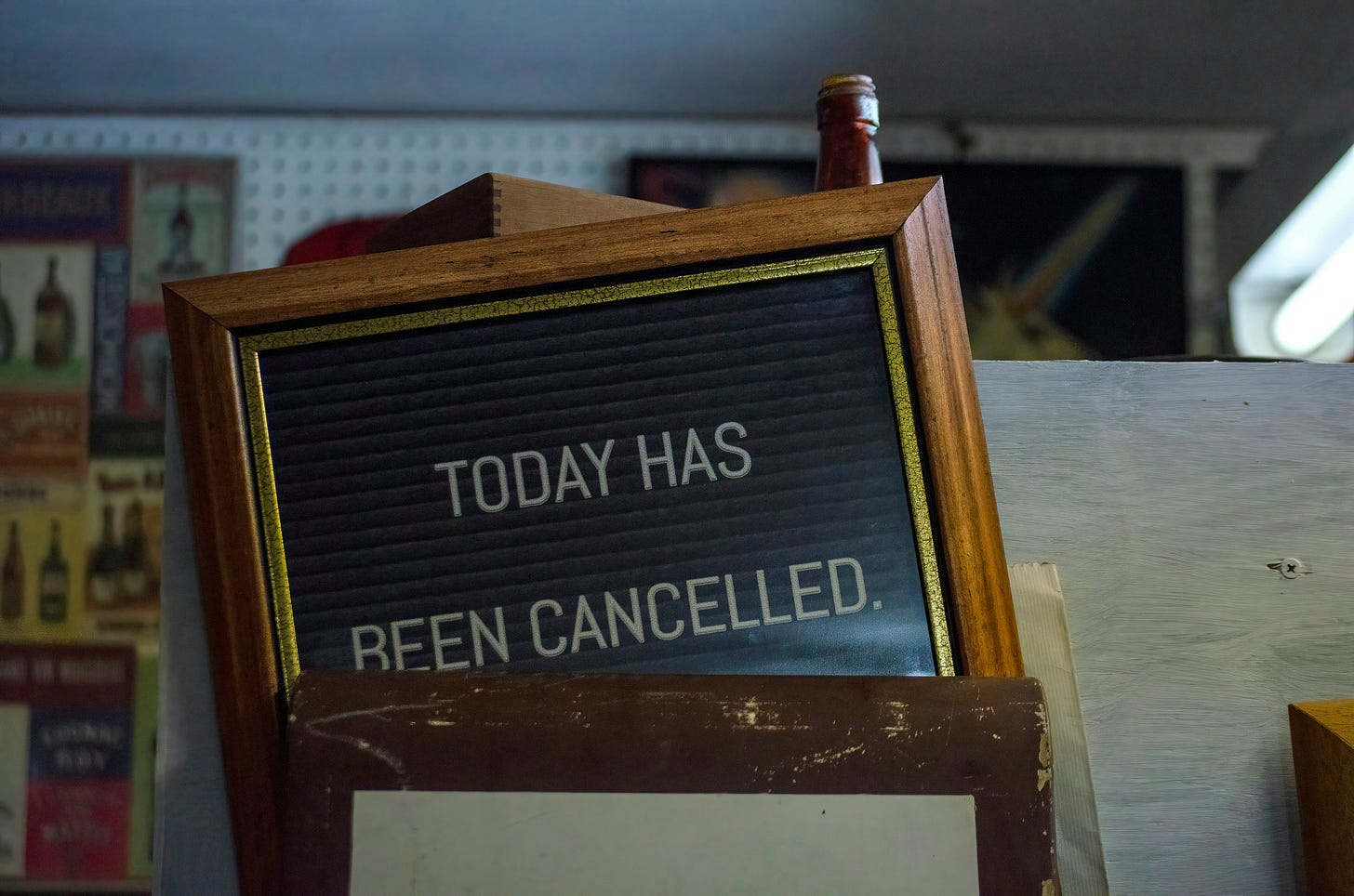 Lopsided letter board in a vintage wood frame with the text "Today has been cancelled."