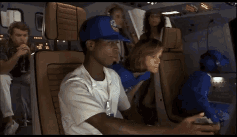 a man wearing a nasa hat is sitting in a chair a man wearing a nasa hat is sitting in a chair