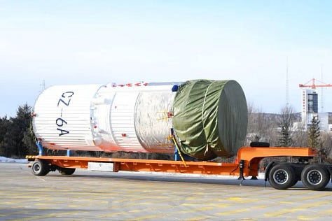 The Long March 6A's first-stage, second-stage, and fairing being transported and placed onto the launch pad.