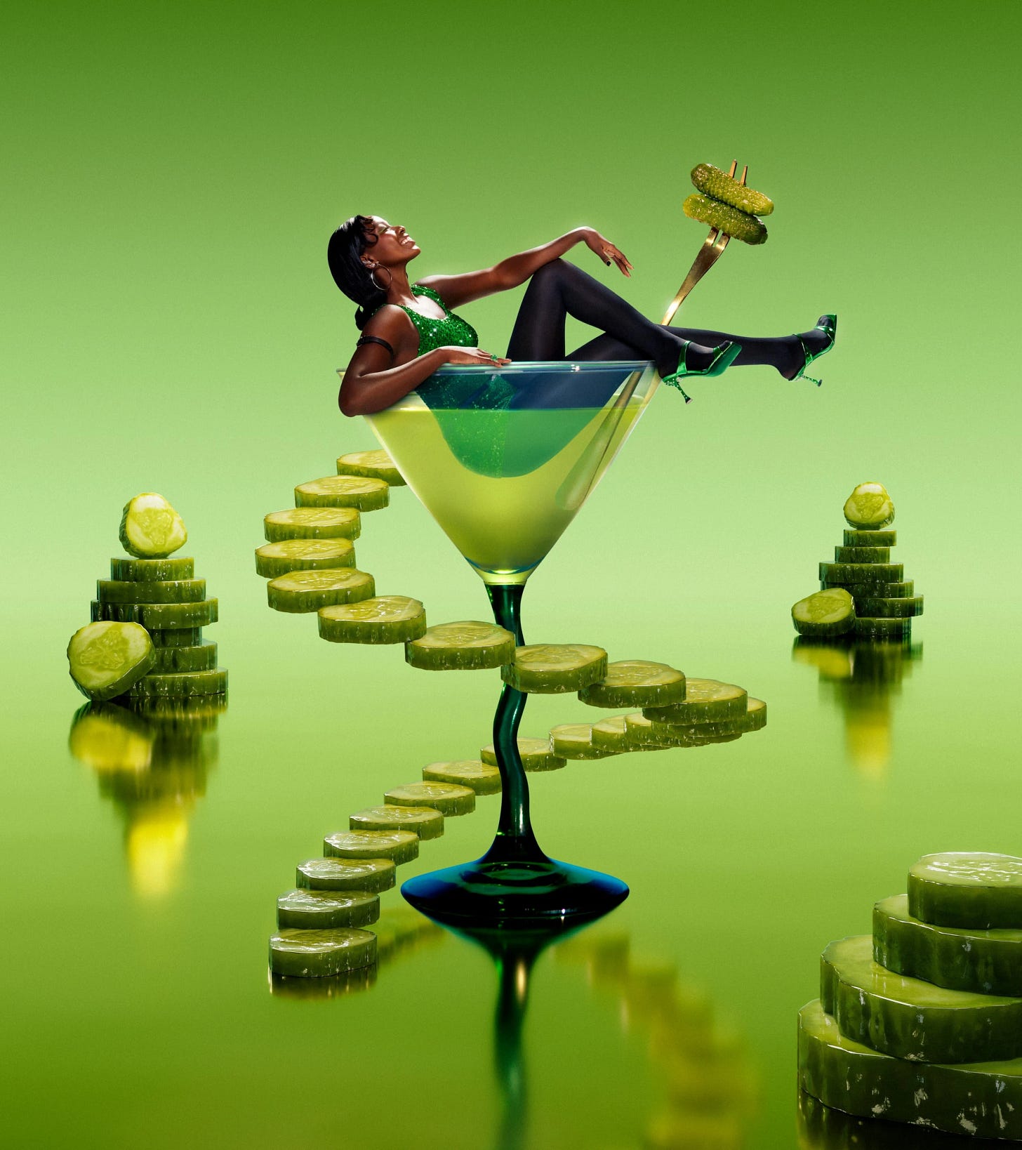 A woman in a green sparkly dress, black tights and metallic-green strappy heels sits in an emerald-green martini glass. The glass has a long, dark-green stem and sits against a light-green background. A woman in a green sparkly dress, black tights and metallic-green strappy heels sits in an emerald-green martini glass. The glass has a long, dark-green stem and sits against a light-green background.
