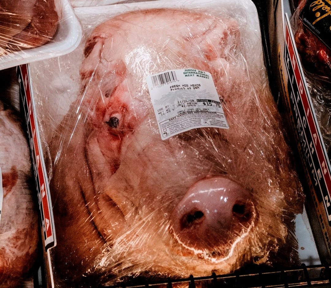 a display of meat in plastic bags in a grocery store a display of meat in plastic bags in a grocery store