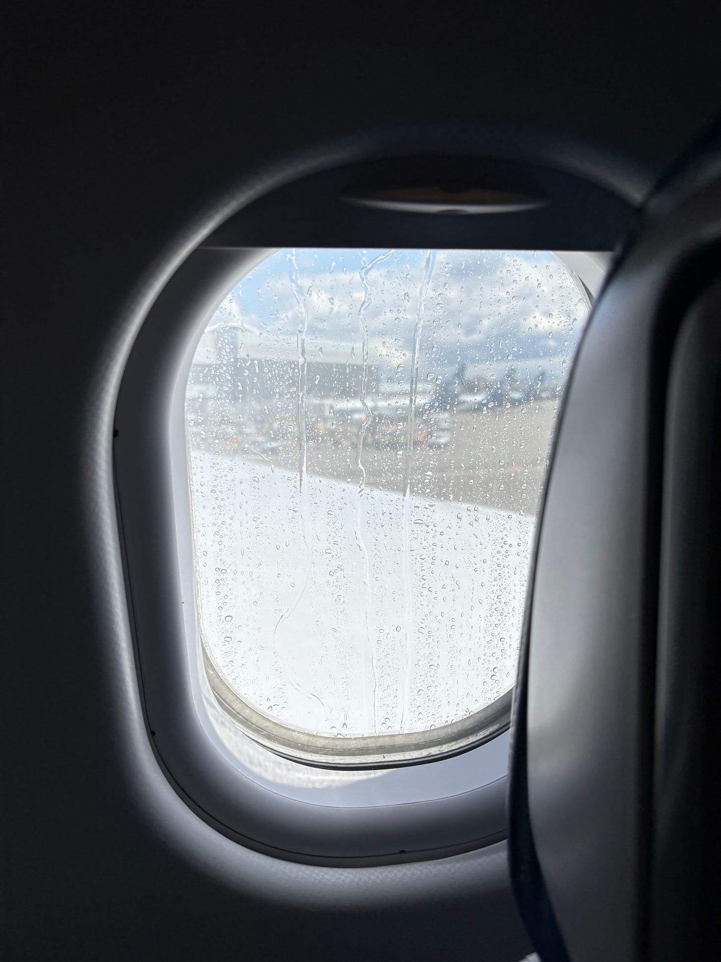 I couldn’t see the fire trucks from my center aisle seat, but saw the result of the water cannon salute. I couldn’t see the fire trucks from my center aisle seat, but saw the result of the water cannon salute.