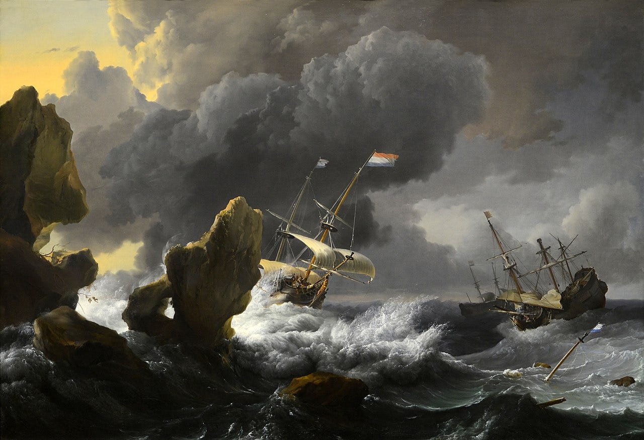 Sailing ships heeling over near rocks in a heavy gale