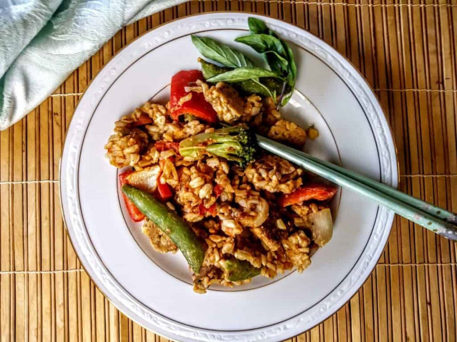 Thai peanut tempeh with rice with chopsticks.