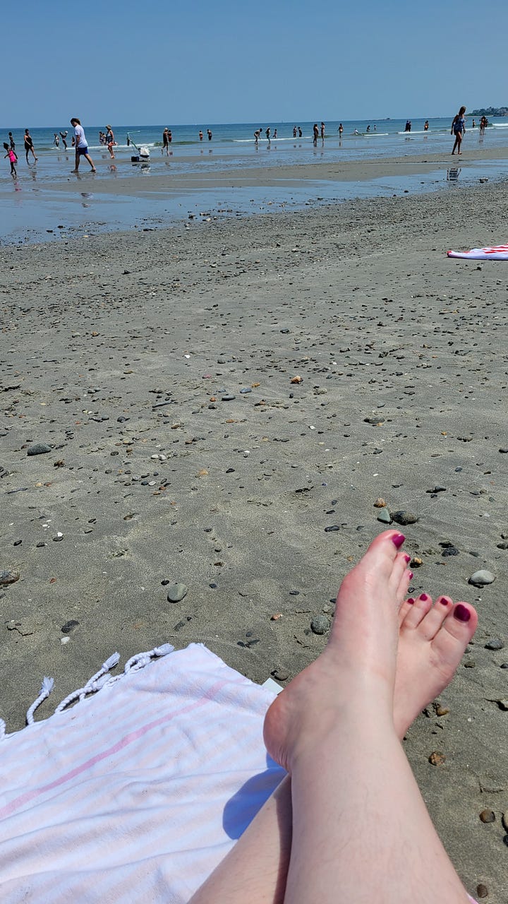 A baguette sandwich; Aliyah's toes in the sand at the beach; Aliyah posing in front of a vineyard; Aliyah holding a handful of small tomatoes just picked from the vine