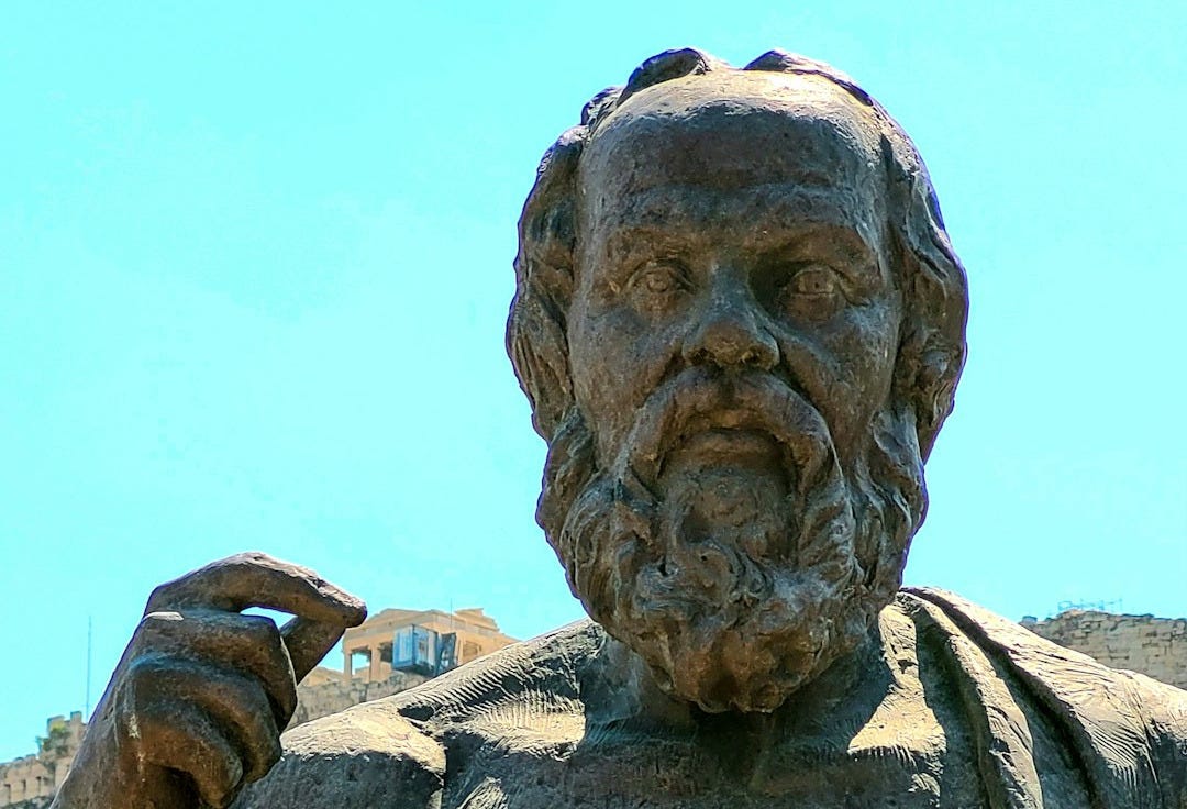 a statue of a man holding a book a statue of a man holding a book