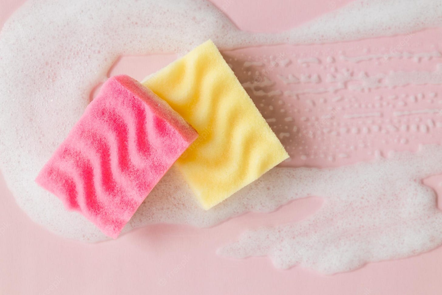 Premium Photo | Yellow and pink sponges with detergent foam on pink  background close up cleaning concept