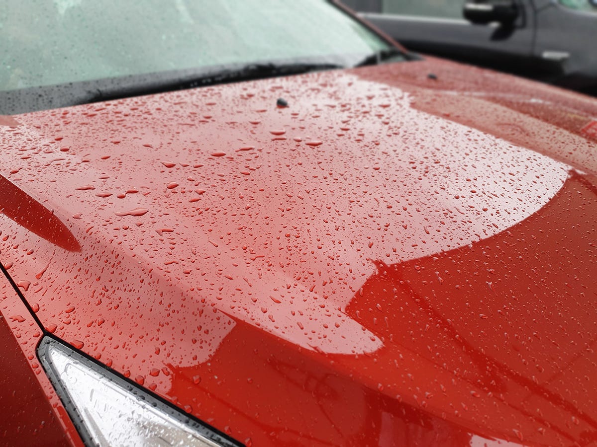 Red car bonnet with raindrops. The actual one from the story. More zoomed out than other 2 pics.