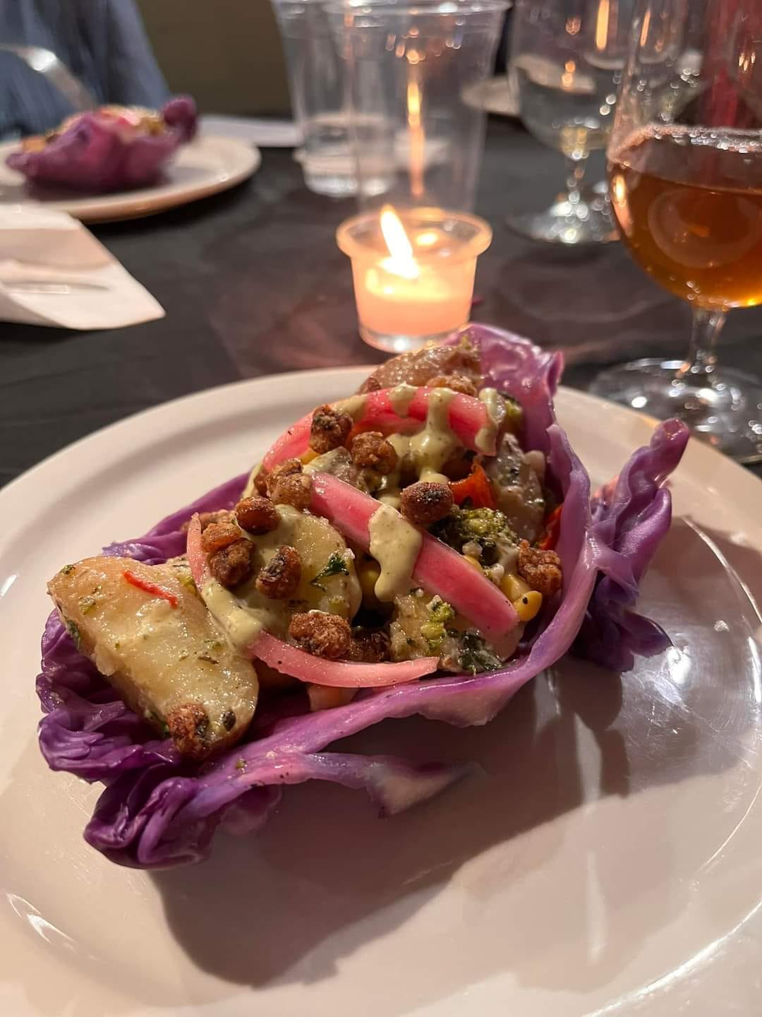 A plate featuring a whole purple cabbage dish, showcasing its vibrant color and texture.