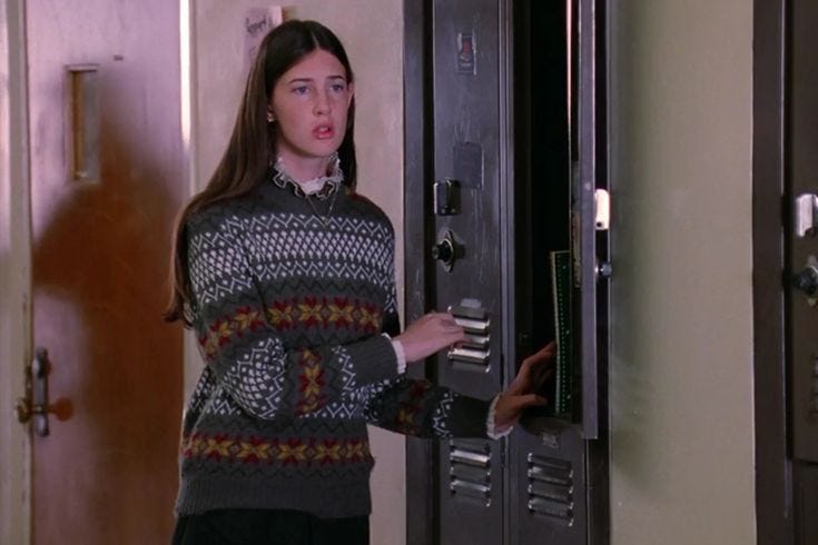 This may contain: a woman standing in front of an open door with her hand on the key board