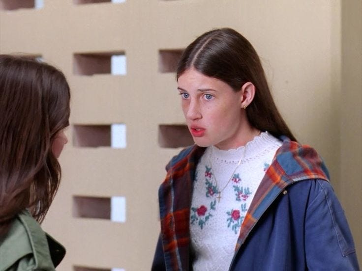 This may contain: two women standing next to each other talking