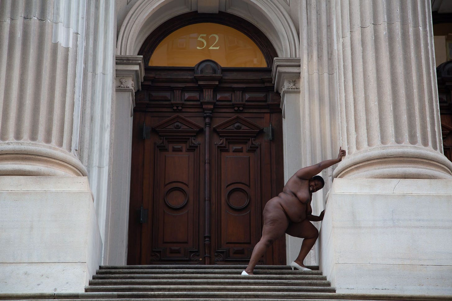 In the 2013 photo "They Tagged The Land With Trophies and Institutions From Their Rapes And Conquests," Nona Faustine poses nude outside the Tweed Courthouse in downtown New York, placing herself — and the viewer — in direct conflict with the building itself. In the 2013 photo "They Tagged The Land With Trophies and Institutions From Their Rapes And Conquests," Nona Faustine poses nude outside the Tweed Courthouse in downtown New York, placing herself — and the viewer — in direct conflict with the building itself.