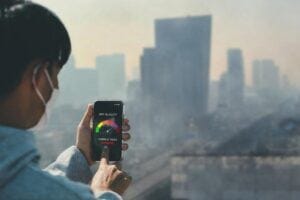 Woman using an air quality app on her cell phone