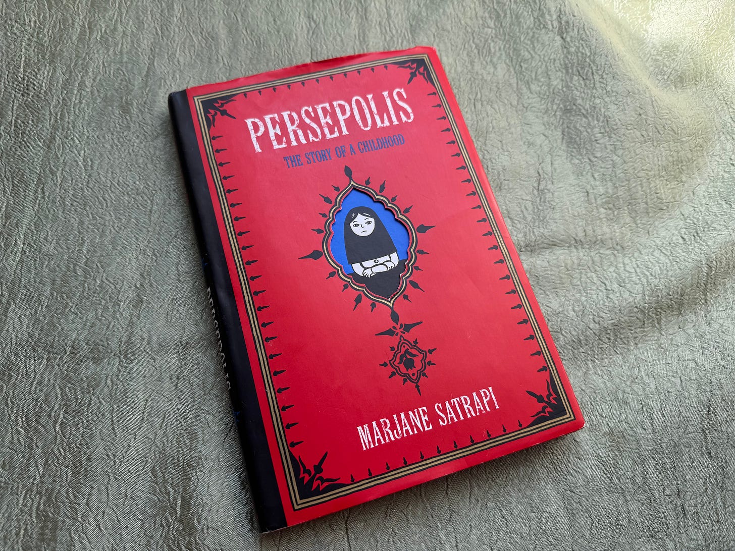 persepolis book with red cover centered over gold fabric persepolis book with red cover centered over gold fabric