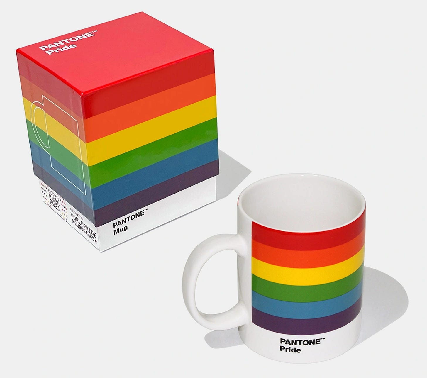 Rainbow-striped mug in front of rainbow-striped carton Rainbow-striped mug in front of rainbow-striped carton