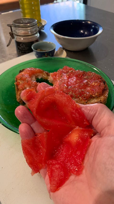 Image shows a green glass plate with a slice of bread smothered in pulped fresh tomato