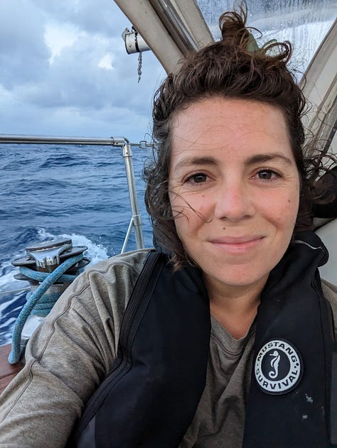 Me on my penultimate morning watch, Isla Mujeres on the horizon, and our boat tied up for entry proceedings.