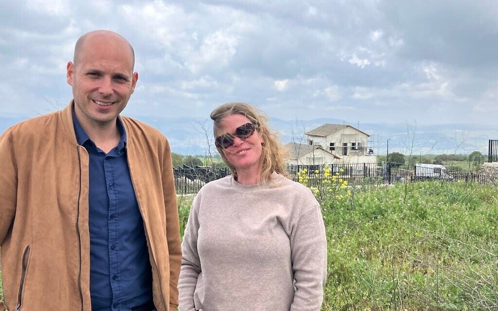 Golan Regional Council Deputy Head Yaakov Selavan, left, stands with Reut Tal-Levy, head of demographic growth in the Golan Heights, in a new neighborhood in Odem, on April 20, 2026. (Diana Bletter/Times of Israel)