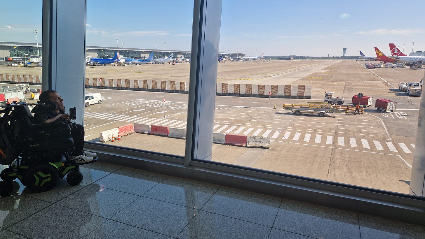 Me looking at the planes out of the airport window 