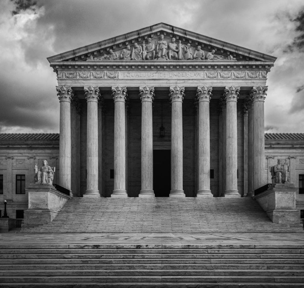 a black and white photo of the supreme court